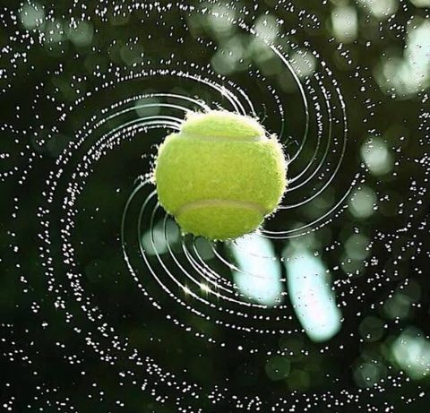 Wet and spinning tennis ball